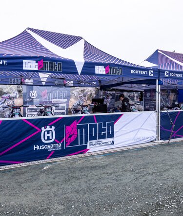 Cat Moto Motocross Team with two Ecotent pop-up gazebos at a European race paddock.